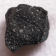 A fragment of the Murchison meteorite, a carbonaceous chondrite fall from Australia.